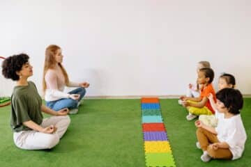 Kids meditating with their teachers